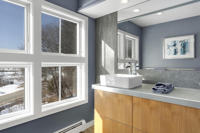 bathroom featuring vanity, plenty of natural light, and a baseboard radiator