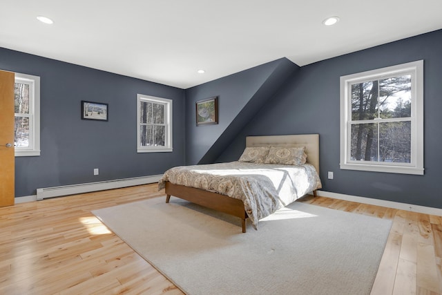 bedroom featuring a baseboard radiator and light hardwood / wood-style floors