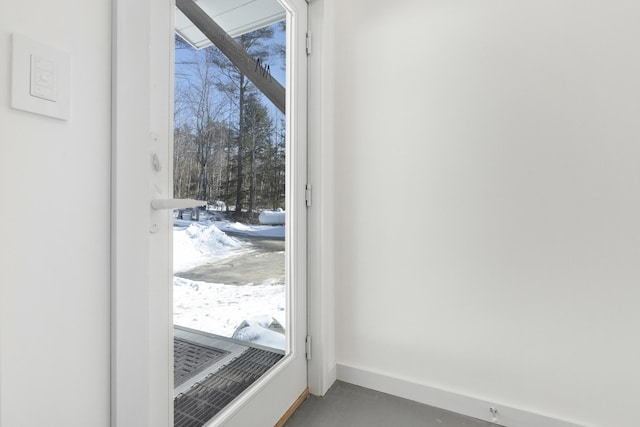 doorway to outside featuring concrete floors