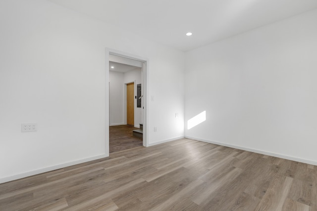 unfurnished room with light wood-type flooring