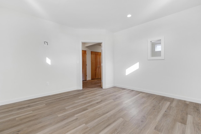 unfurnished room with light hardwood / wood-style flooring