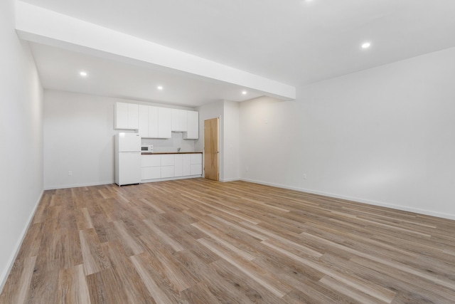 unfurnished living room with light wood-type flooring