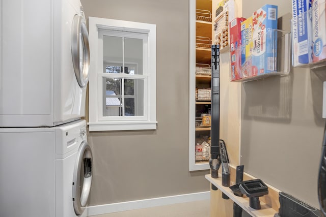 washroom featuring stacked washing maching and dryer