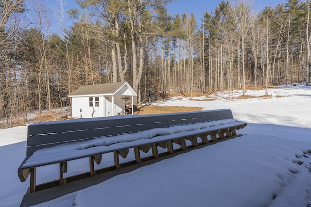 yard layered in snow with an outdoor structure