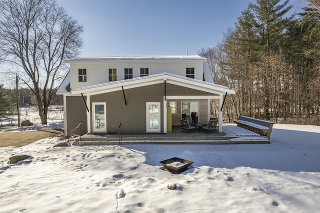 snow covered property featuring a porch