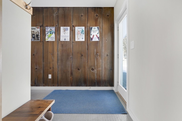 foyer featuring wooden walls