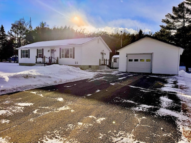 view of front of house with a garage and an outbuilding