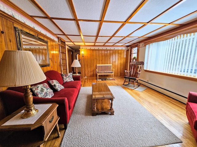 living room featuring baseboard heating, hardwood / wood-style floors, and coffered ceiling