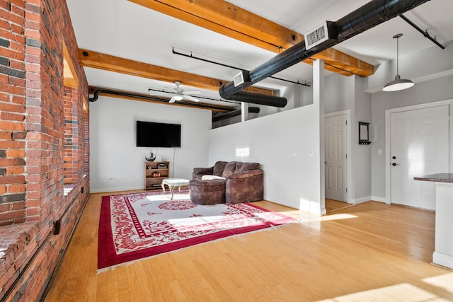 living room with ceiling fan and hardwood / wood-style floors