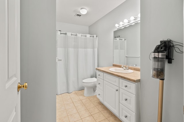 bathroom featuring toilet, vanity, a shower with curtain, and tile patterned floors