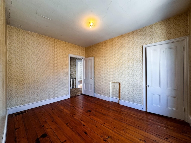 empty room featuring dark hardwood / wood-style flooring