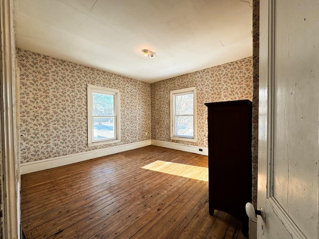 spare room featuring wood-type flooring