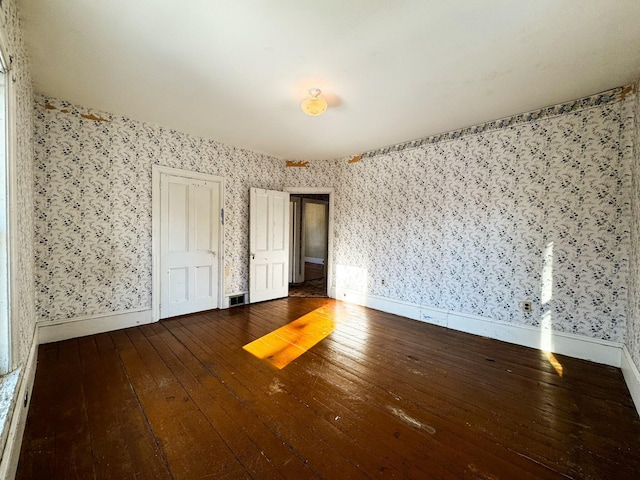 unfurnished bedroom with hardwood / wood-style floors