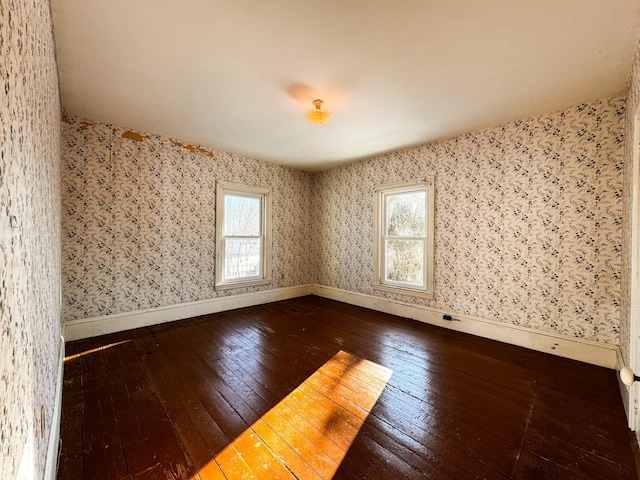 spare room with hardwood / wood-style floors and a wealth of natural light