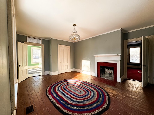 unfurnished living room featuring crown molding and dark hardwood / wood-style flooring