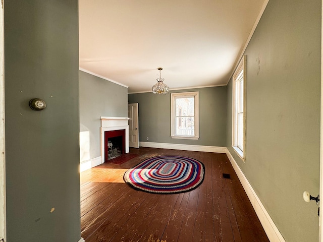 unfurnished living room with crown molding and wood-type flooring