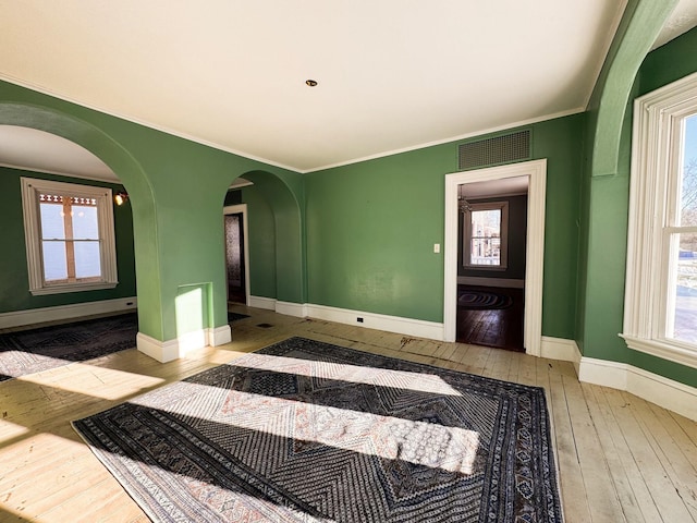 interior space featuring crown molding and light wood-type flooring