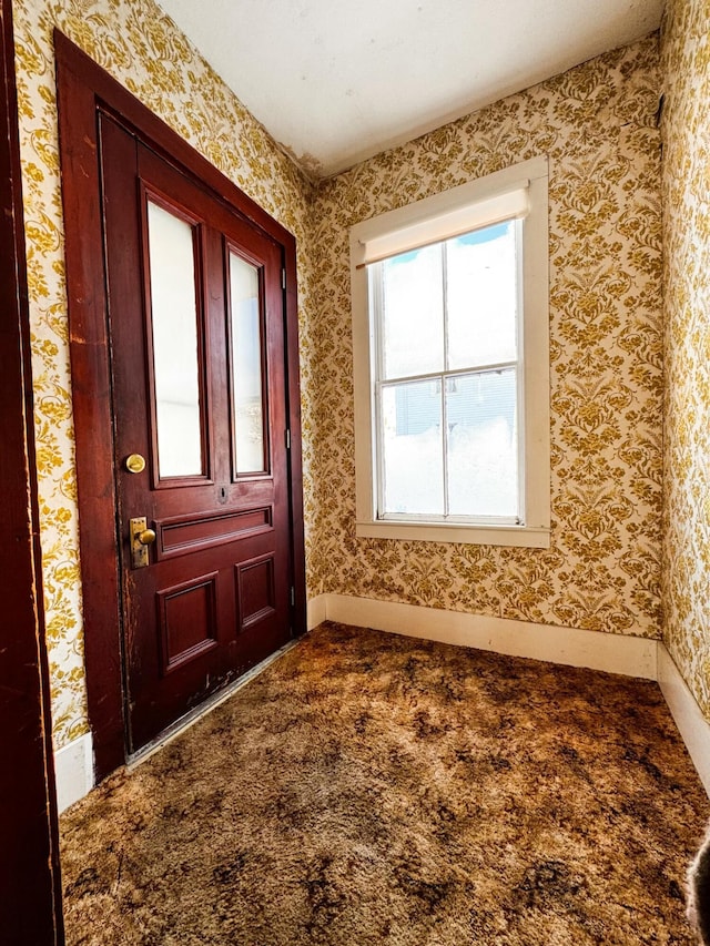 view of carpeted foyer entrance