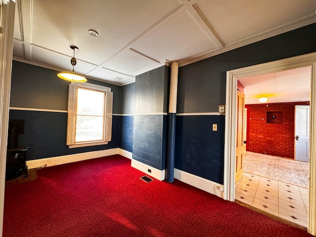 spare room with ornamental molding and carpet