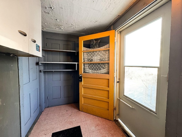 doorway to outside featuring plenty of natural light and tile patterned floors