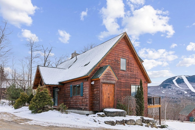 view of snow covered exterior with a mountain view