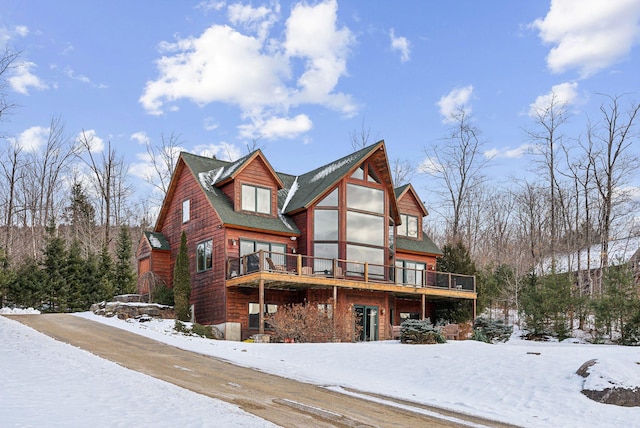 log home with a wooden deck