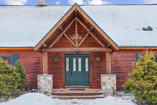 view of snow covered property entrance