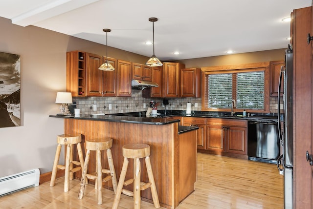 kitchen featuring a baseboard radiator, black dishwasher, a kitchen breakfast bar, backsplash, and kitchen peninsula