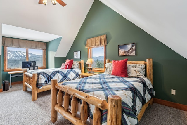 bedroom with ceiling fan, vaulted ceiling, and carpet floors