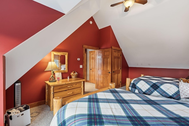 carpeted bedroom with ceiling fan and lofted ceiling