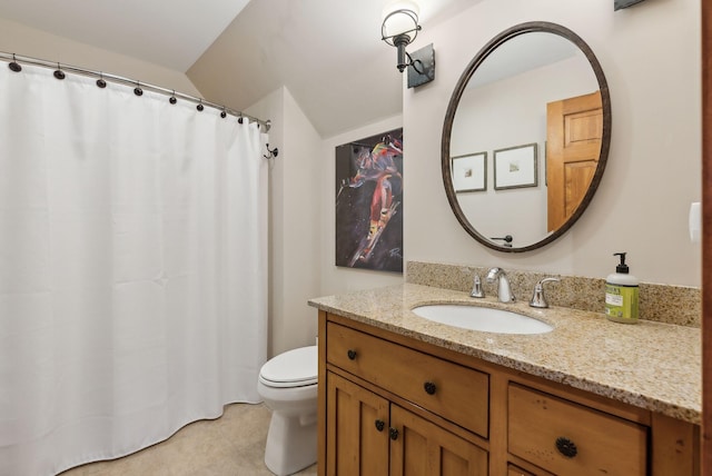 bathroom featuring lofted ceiling, vanity, and toilet