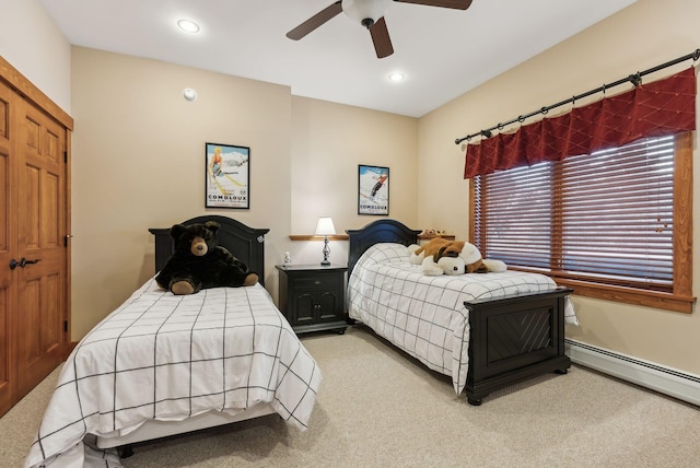 carpeted bedroom featuring ceiling fan and baseboard heating