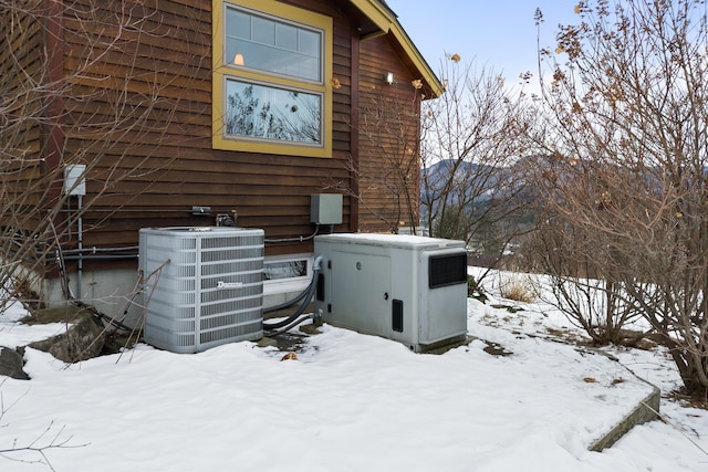 view of snowy exterior with central air condition unit