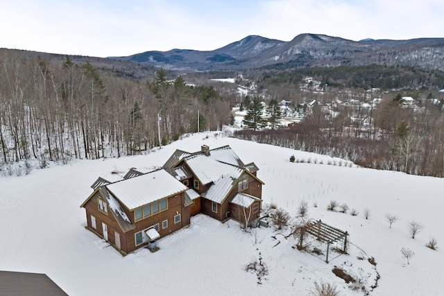 snowy aerial view with a mountain view