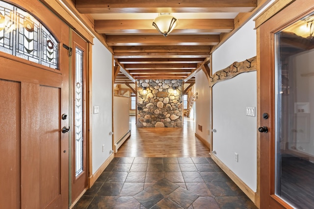 entryway with baseboard heating, a healthy amount of sunlight, and beam ceiling