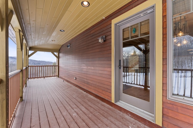 wooden deck featuring a mountain view and a porch