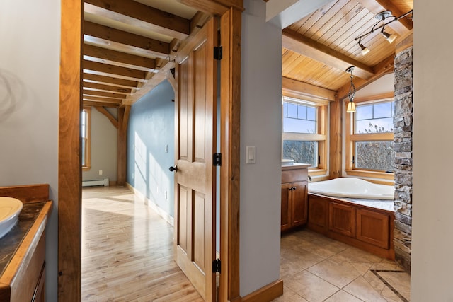 bathroom with lofted ceiling with beams, vanity, a bathtub, and wood ceiling