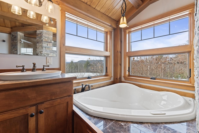 bathroom featuring wooden ceiling, lofted ceiling, plenty of natural light, and vanity