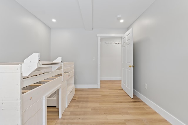 interior space featuring light hardwood / wood-style flooring and beamed ceiling