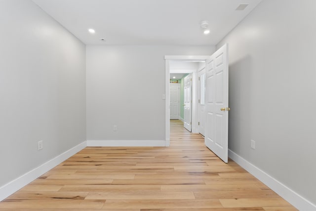 empty room with light hardwood / wood-style flooring