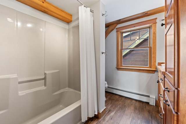 bathroom with a baseboard radiator, wood-type flooring, toilet, and shower / tub combo