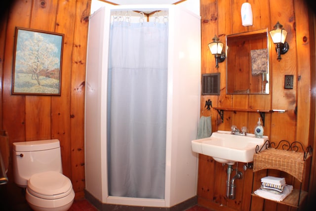 37 Treasure Island Rd, Shapleigh, ME 04076 - bathroom featuring a stall shower, wooden walls, toilet, baseboards, and a sink