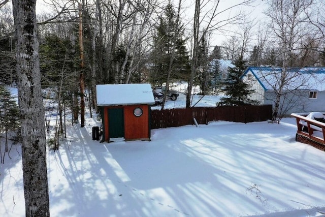 yard covered in snow with a shed