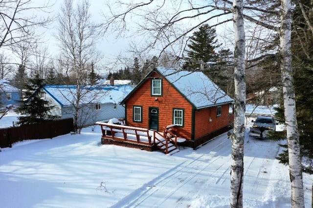 snow covered property with a deck