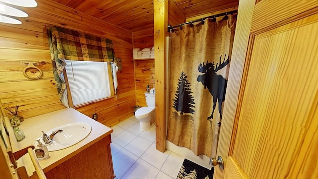 bathroom with toilet, wood ceiling, vanity, wooden walls, and tile patterned flooring