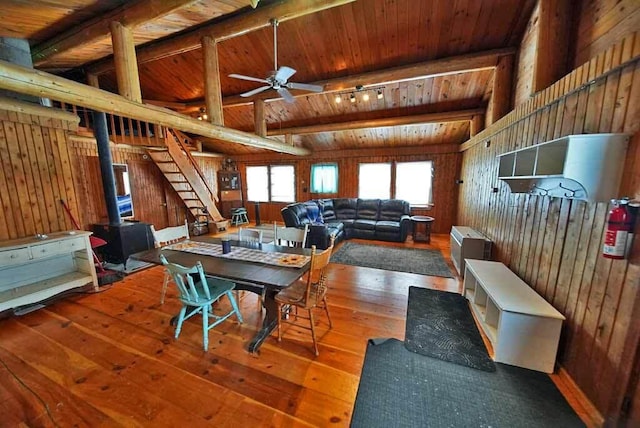 dining room with lofted ceiling with beams, hardwood / wood-style flooring, wooden ceiling, and ceiling fan