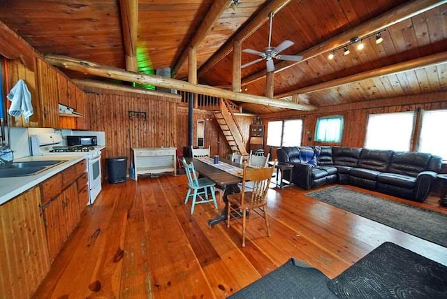 living room featuring wood walls, wooden ceiling, track lighting, ceiling fan, and hardwood / wood-style floors