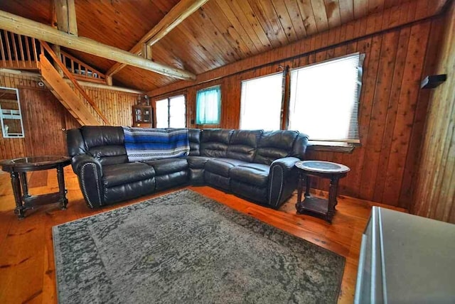 living room featuring hardwood / wood-style flooring, plenty of natural light, and wooden walls