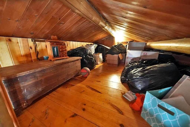 additional living space featuring wood-type flooring, wooden ceiling, and wood walls