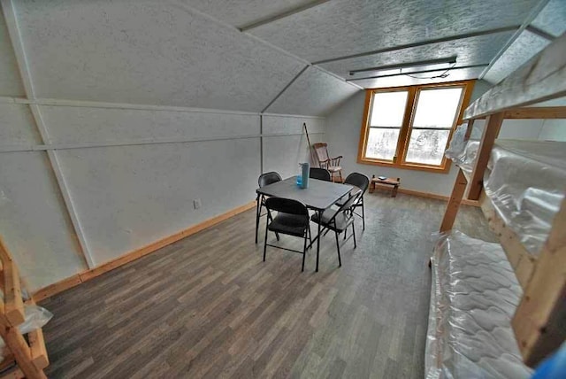 interior space featuring lofted ceiling and wood-type flooring